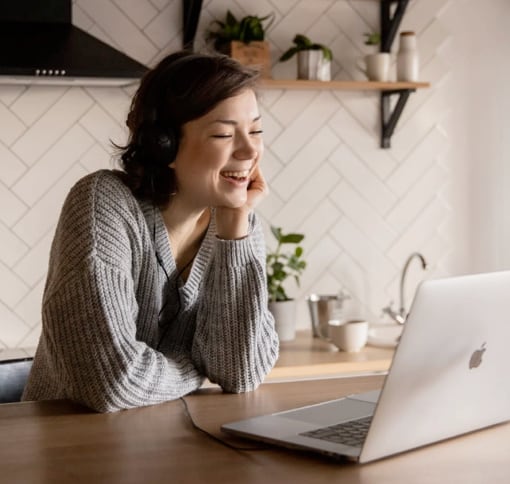 A woman having a videocall on her laptop